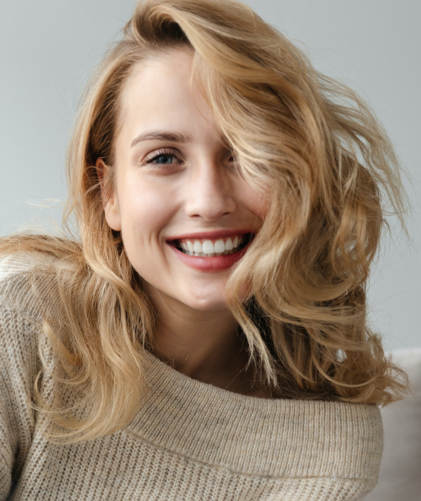 Photo of a smiling blonde woman with great skin