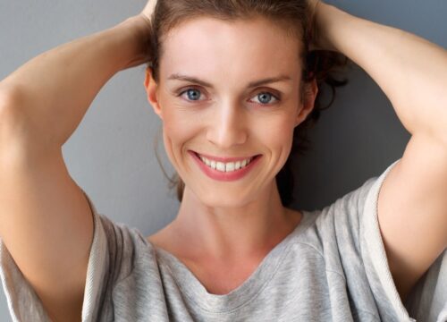 Photo of a smiling woman with blue eyes and great skin