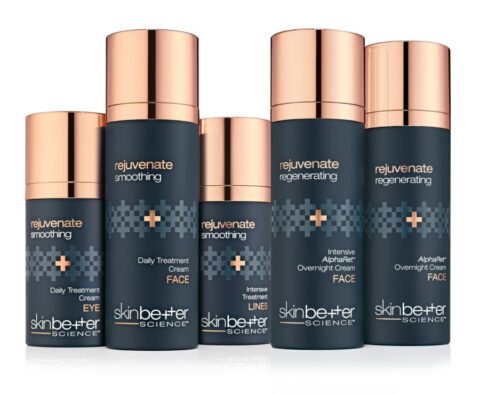 Five Skinbetter Science skincare bottles with dark blue bodies and rose gold caps, labeled as rejuvenate smoothing and regenerating treatments for eyes and face.